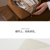 A brown cosmetic storage bag is shown open, displaying various beauty products inside.