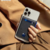 A hand holds a slim black RFID-blocking wallet with a blue accent against a brown jacket.