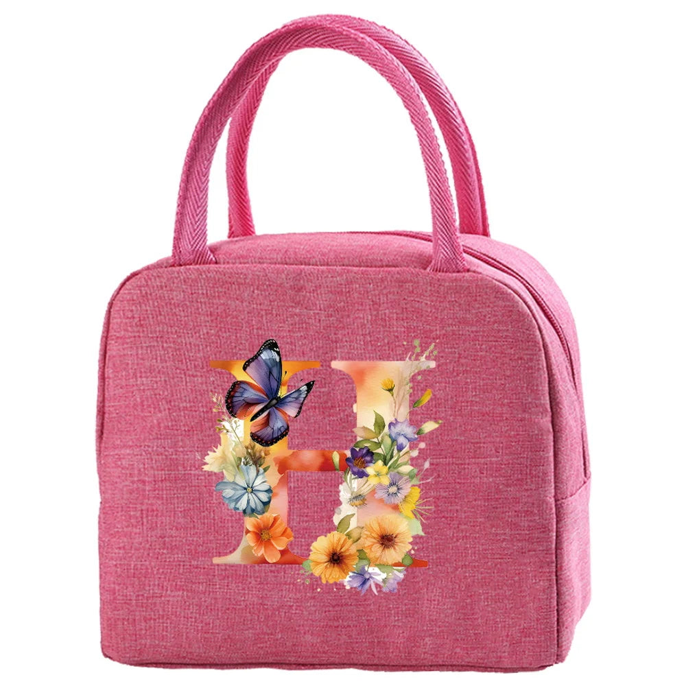 A pink insulated canvas lunch bag with a handle featuring a large letter H design.