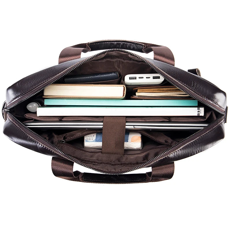A dark brown genuine cowhide leather briefcase bag open to show organized compartments and various items.