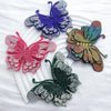 Four decorative rhinestone butterfly appliqués stickers in purple, pink, green, and multicolored hues on a white background