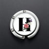 Silver foldable letter Hanger hook for accessories with a floral design.