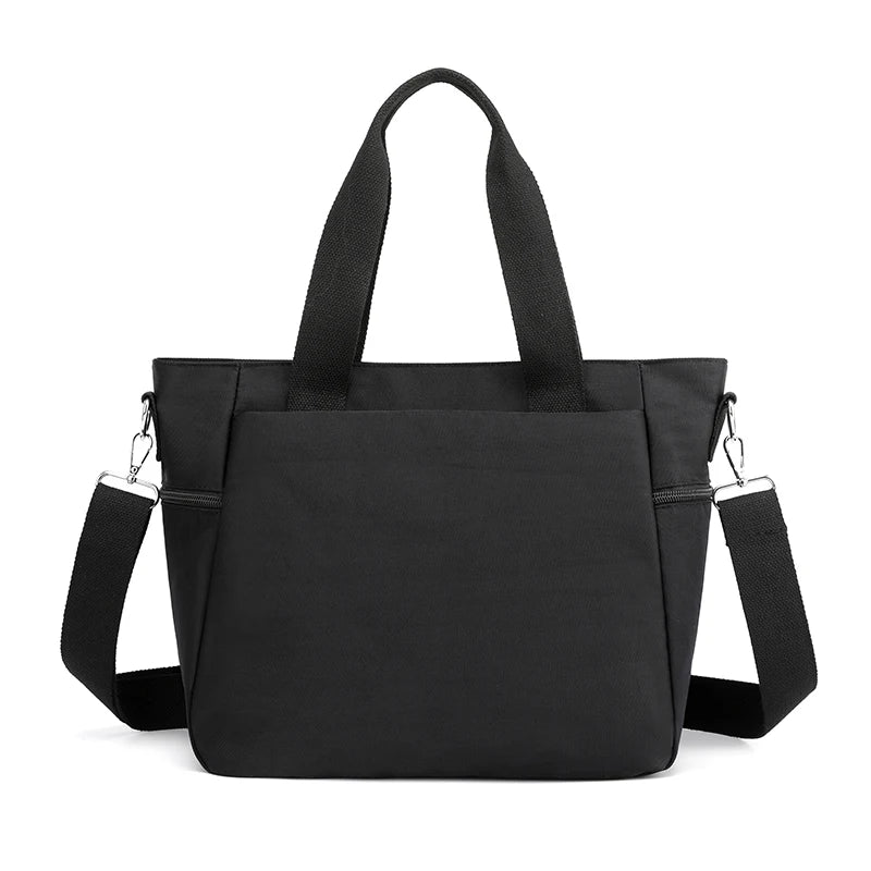 A black durable nylon tote bag with black straps and a zipper closure.