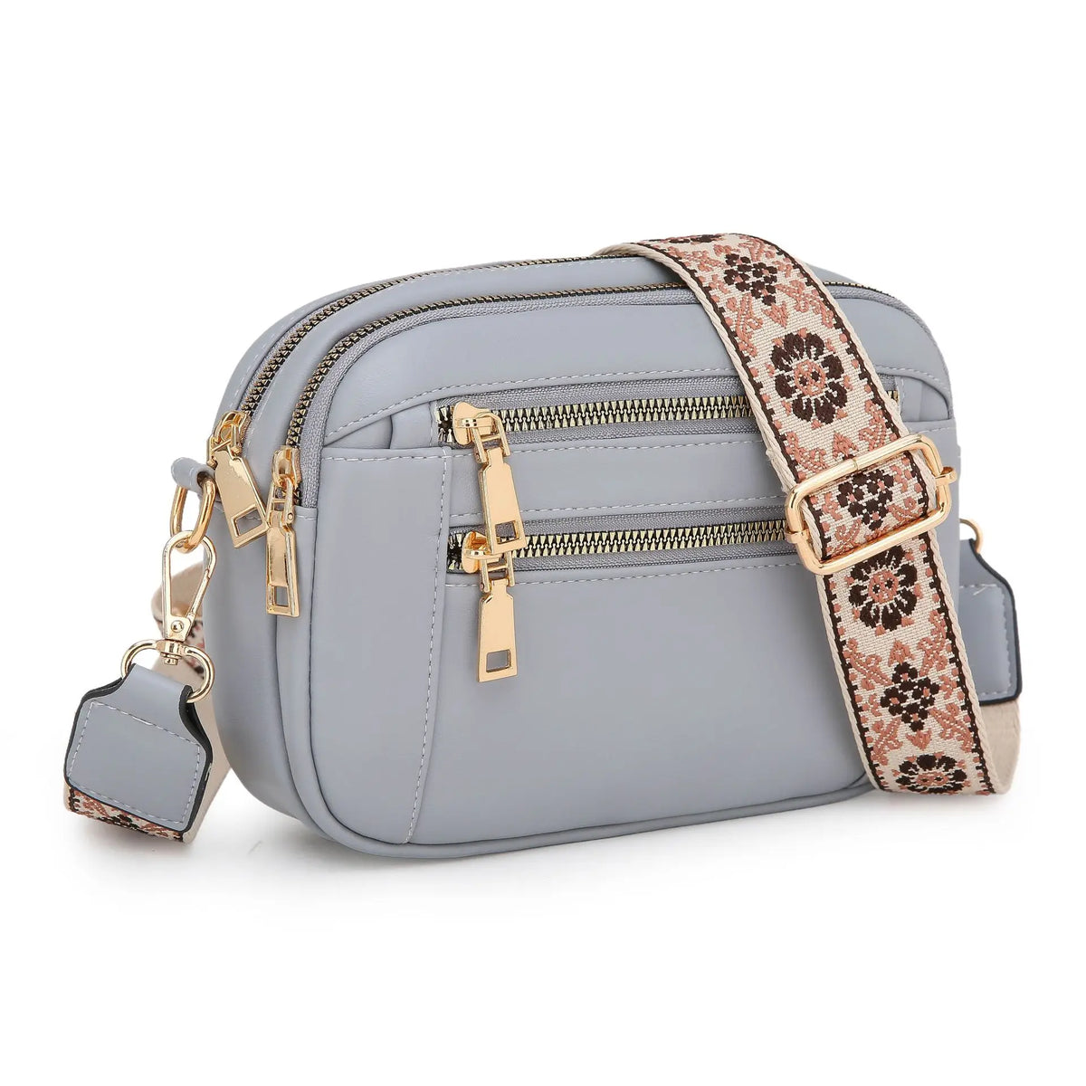 A light blue PU leather crossbody bag with gold hardware and a patterned strap.
