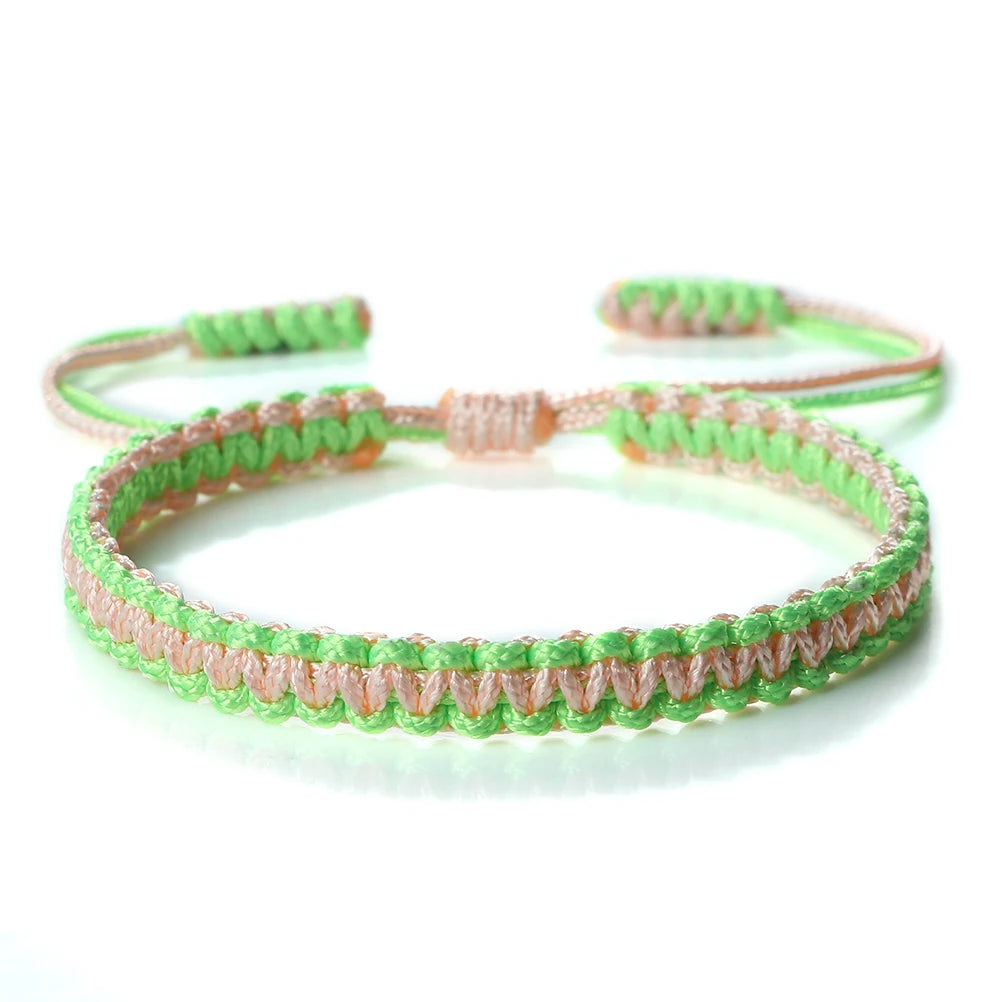 Handmade braided rope bracelet with pink and green threads, featuring an adjustable closure.