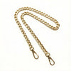 A gold-colored metal chain crossbody strap laid out against a white background.
