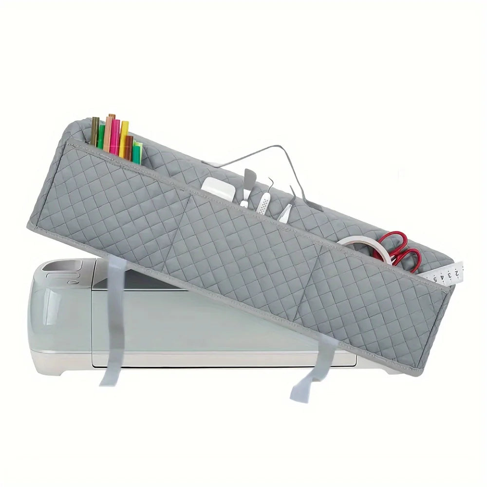 A gray protective cover for a Cricut Maker, featuring a quilted design and holding colored pens.