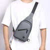 A gray men's adjustable chest crossbody sling bag worn by a person in a white t-shirt.