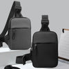 A black Oxford chest bag for men with a shoulder strap is shown against a light gray background.