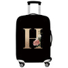 Black rolling suitcase with a gold initial H design on the side.