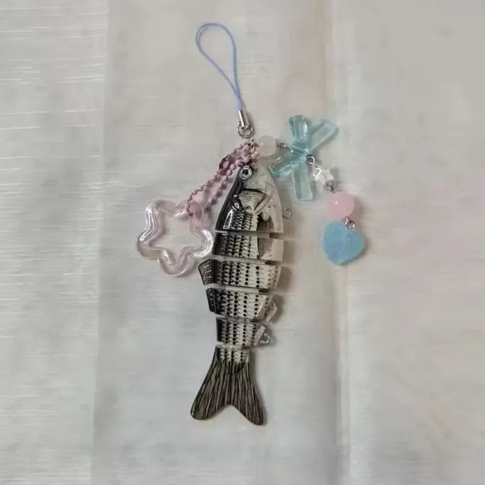 Silver simulation fish keychain with pink and blue accents on a clear cord