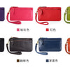 A collection of genuine leather wristlet clutch wallets in various colors including purple, pink, red, green, black, brown, d