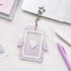 Clear acrylic photocard holder with a heart design and angel wings attached to a silver charm.