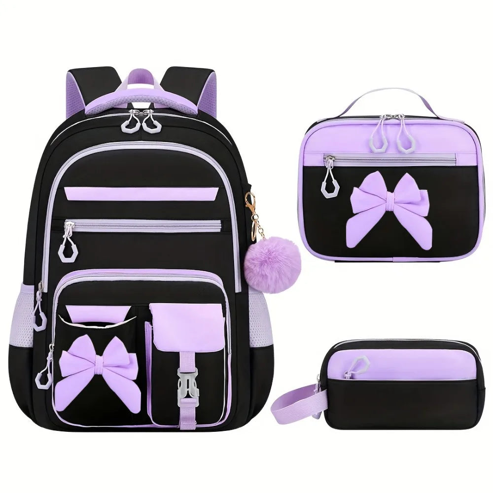 A set of three purple and black cartoon school bags for girls, including a backpack and two small pouches.