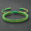 Handmade braided rope bracelet featuring green and yellow threads, suitable as a friendship gift.