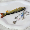 A simulation fish keychain featuring a realistic model of a fish with iridescent scales and a gold-colored body.