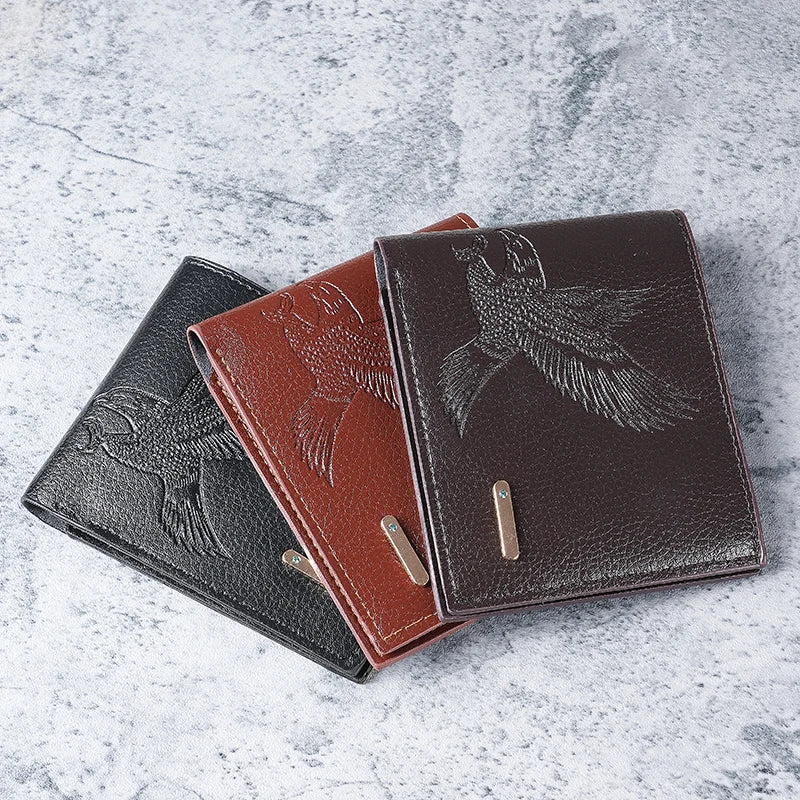A brown leather wallet with an embossed eagle design is shown lying on a light gray surface.