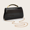 A black leather clutch purse with a gold-toned handle and chain strap is displayed against a light background.