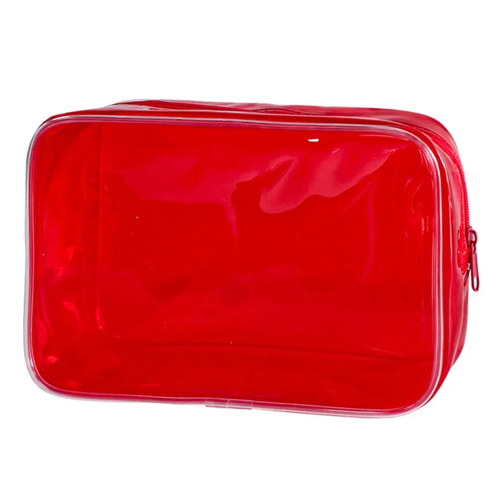 A bright red transparent PVC travel makeup bag with a zipper closure.