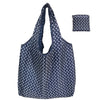 A navy blue reusable tote bag with white polka dots, shown from the front and a separate folded example.