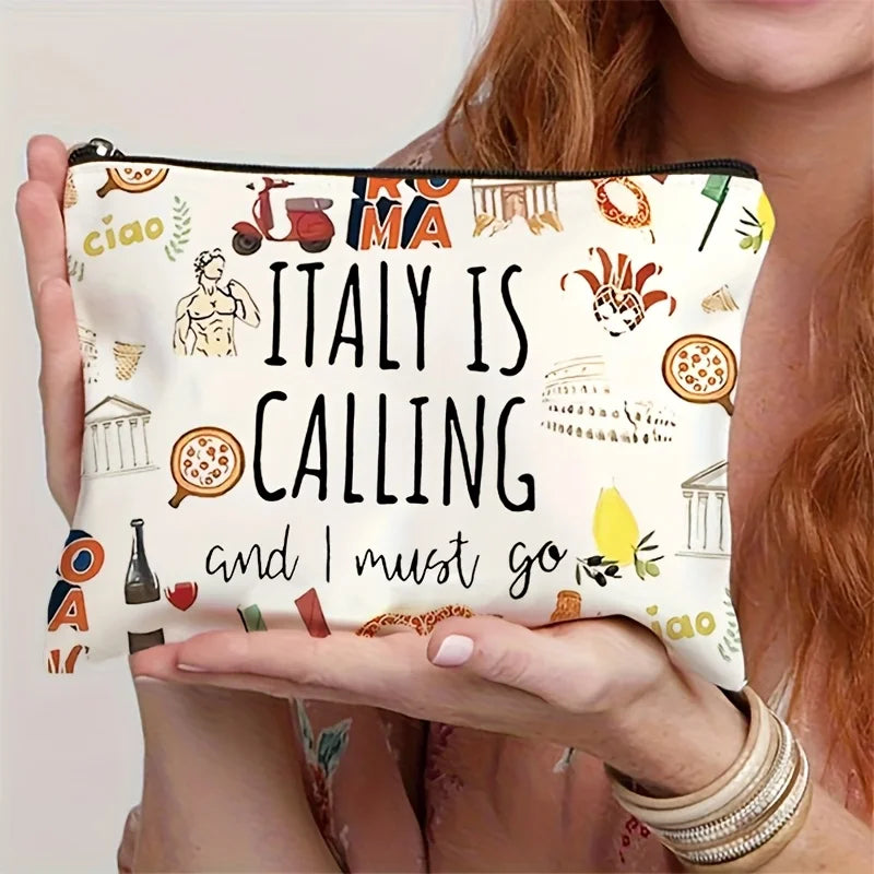 A hand holds a large capacity Italian souvenir makeup bag featuring text and illustrations.