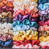A collection of 19 thin scrunchies hair ties in various pastel and vibrant colors stacked together.
