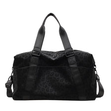 Black leopard print duffle bag with adjustable straps