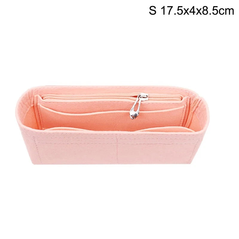 A pink felt bag insert organizer with a zipper closure shown from the top.