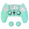 A teal silicone grip cover for a PlayStation controller featuring a cat design and paw buttons.