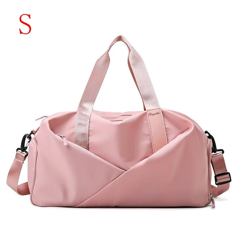 A pink nylon gym and travel duffel bag with wet and dry separation features.