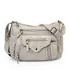 A light beige luxury leather tote bag with silver hardware and a flap closure.