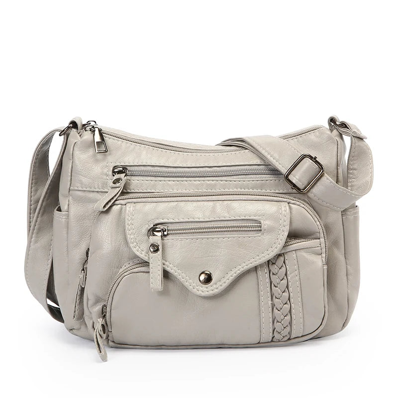 A light beige luxury leather tote bag with silver hardware and a flap closure.