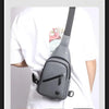 A gray men's adjustable chest crossbody sling bag being worn by a person in a white shirt, demonstrating its use for various 