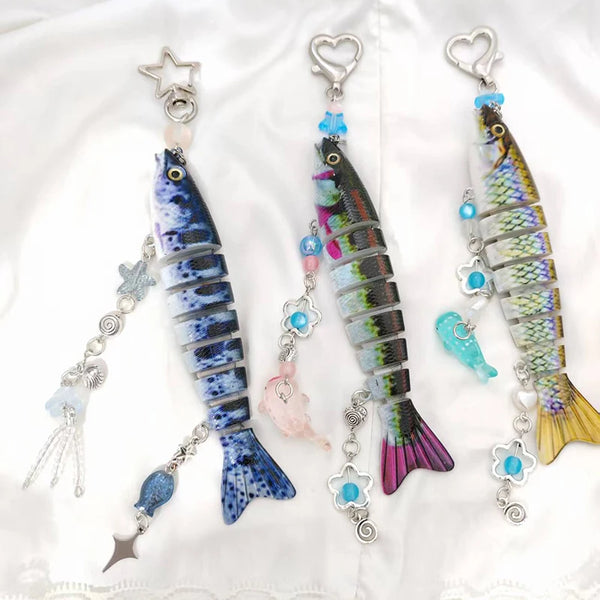 A set of fish-themed acrylic keychain charms featuring iridescent blue and green fish designs.