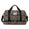 A black leopard print travel duffel bag with handles and a zippered compartment.