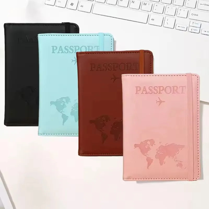 A set of three slim passport holders in black, light blue, and pink leather.