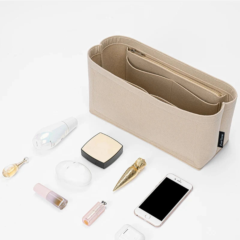 A tan felt bag organizer insert is shown with various small electronic items and accessories on a white background.