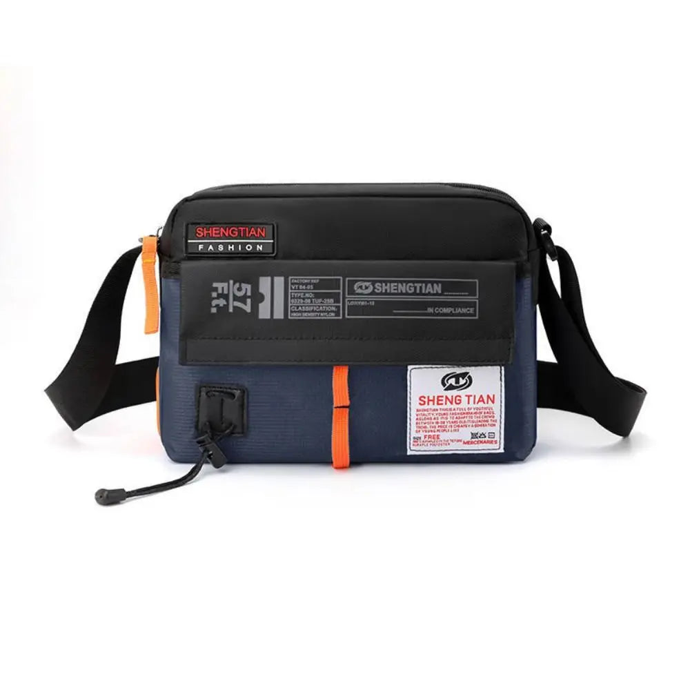 A dark blue waterproof nylon crossbody bag with a black strap and branding labels.