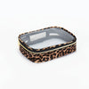 A leopard print cosmetic bag with a clear lid and gold trim, designed as a waterproof travel organizer.
