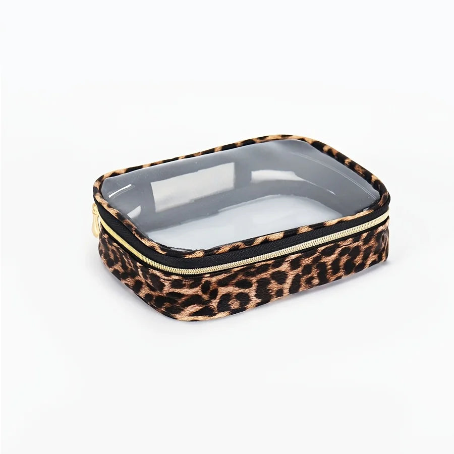 A leopard print cosmetic bag with a clear lid and gold trim, designed as a waterproof travel organizer.