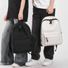 A person is holding a white leisure shoulder backpack and black pants.