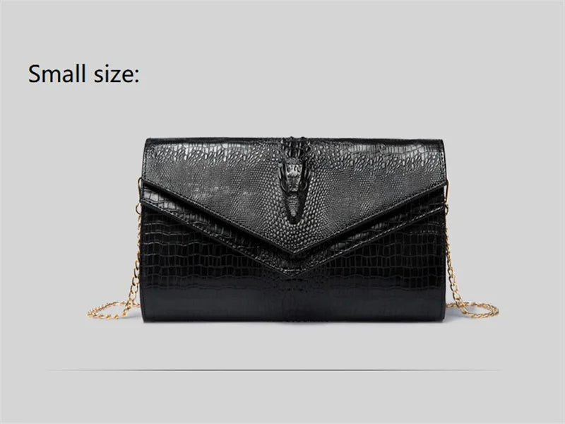 Black alligator pattern leather clutch bag with gold chain detail.