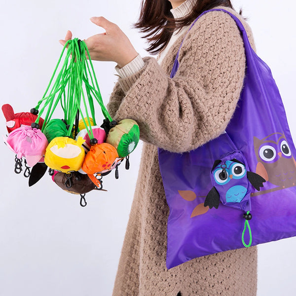 A hand holds a purple foldable eco-friendly cartoon shopping bag filled with colorful plastic toys and green string decoratio