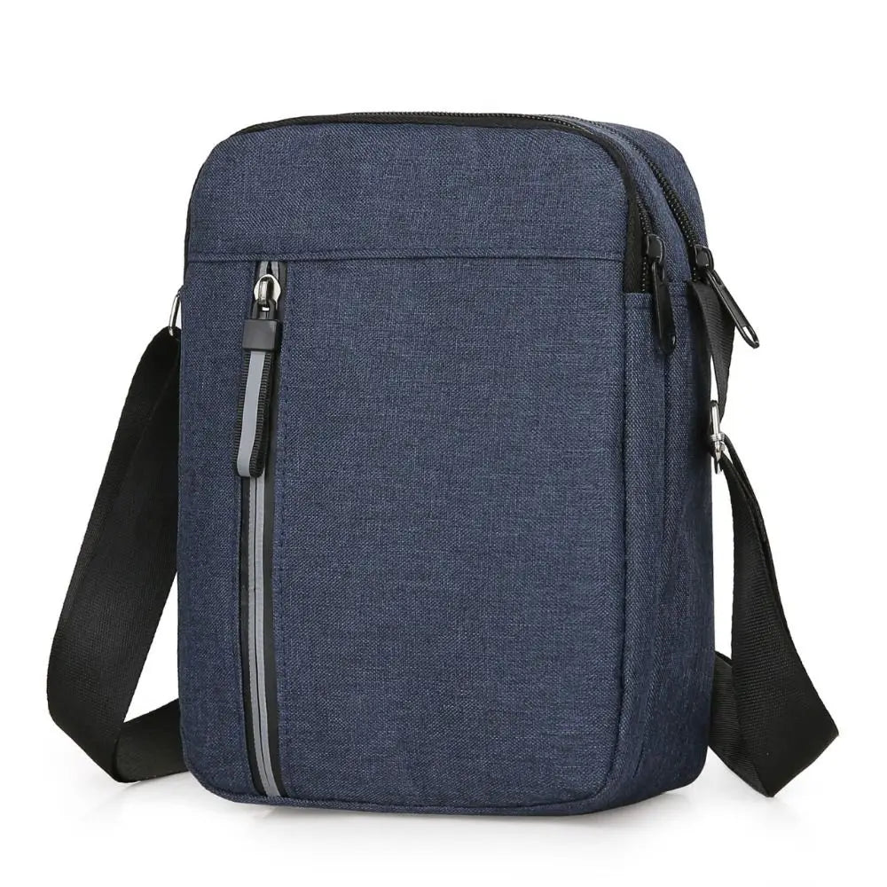 A navy blue durable waterproof crossbody bag with black trim and strap.