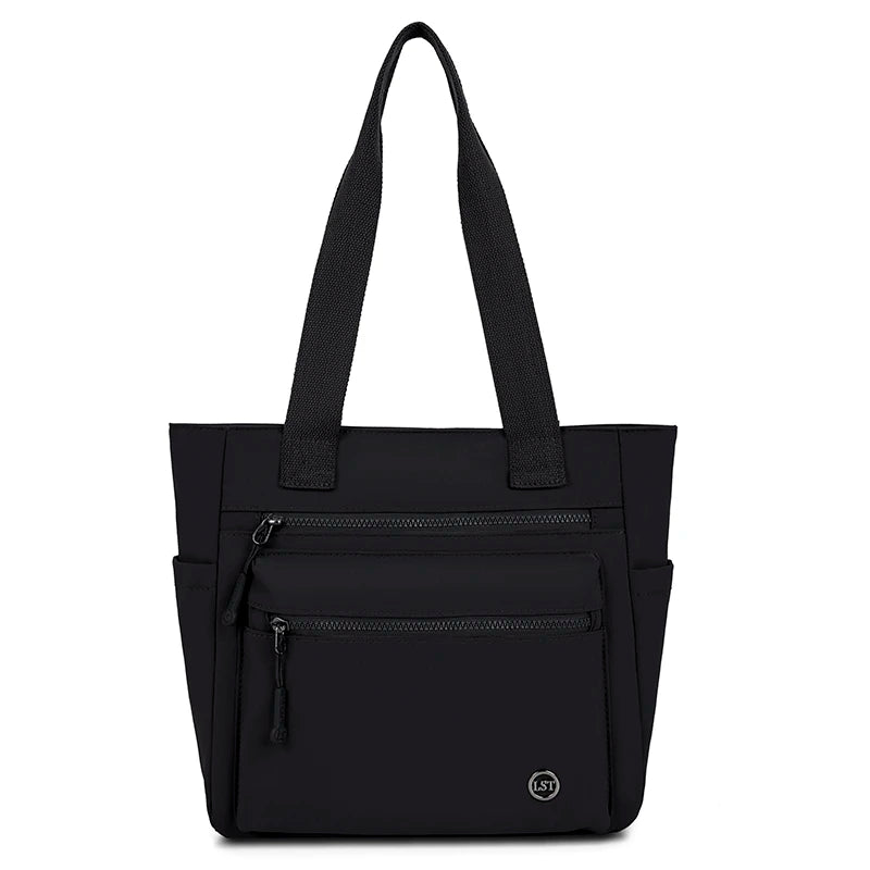 A black canvas tote bag with two zippered pockets and black fabric handles.