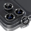 A close-up view of a silver glitter diamond camera lens protector with a metal frame for an iPhone.