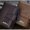 A brown leather card holder wallet is shown resting on a wooden surface next to a rolled-up document.