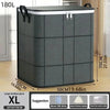 A gray foldable storage organizer bag with a black lid and handles is shown on a wooden floor.