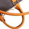 Close-up of an orange leather replacement shoulder strap attached to a dark gray handbag.