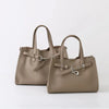 A beige genuine leather women's shoulder tote bag with silver hardware.